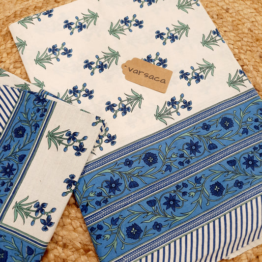 White and Blue Hand Block Print King Size Bedsheet With Blue Floral Motifs , Green Leaves And Blue Striped Border