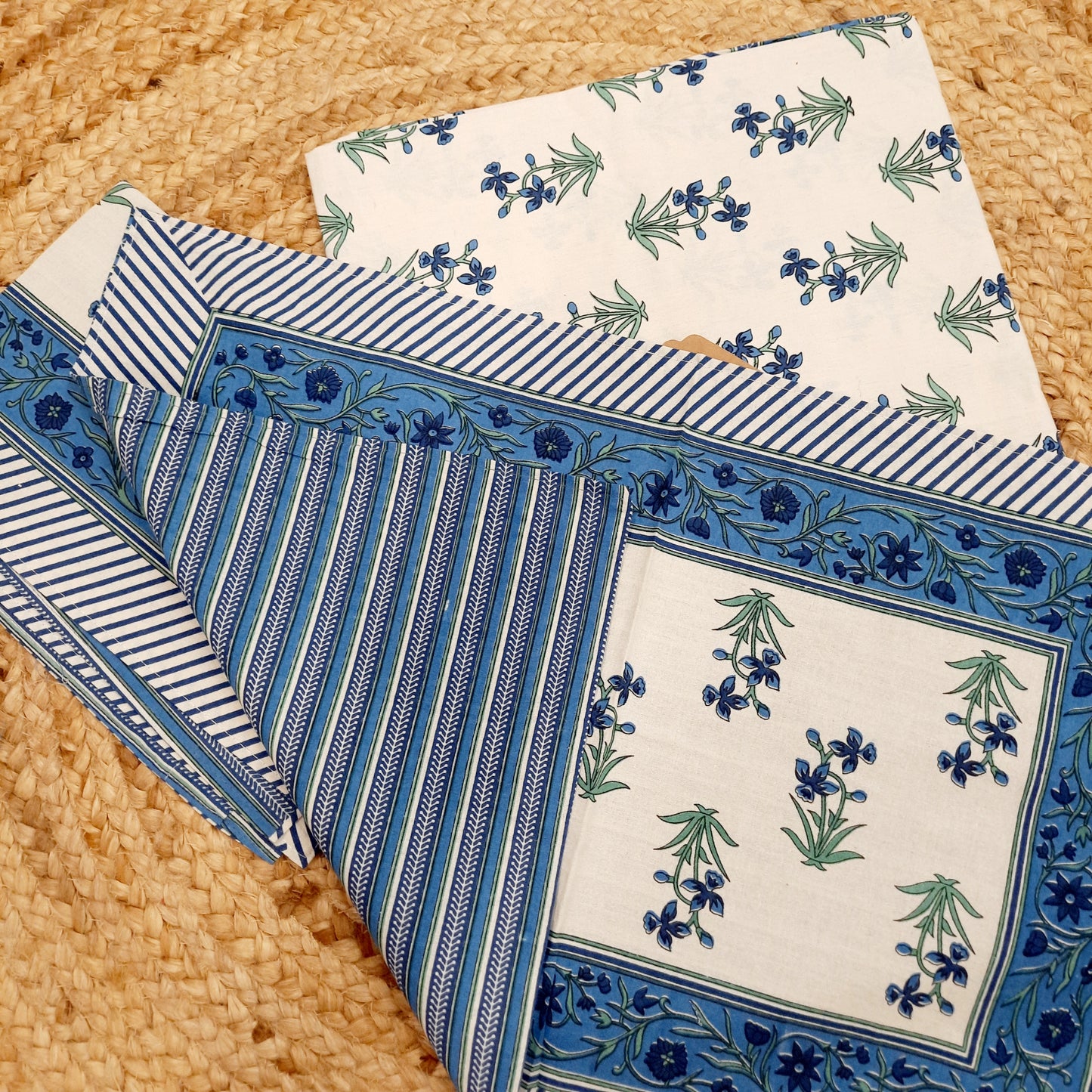 White and Blue Hand Block Print King Size Bedsheet With Blue Floral Motifs , Green Leaves And Blue Striped Border