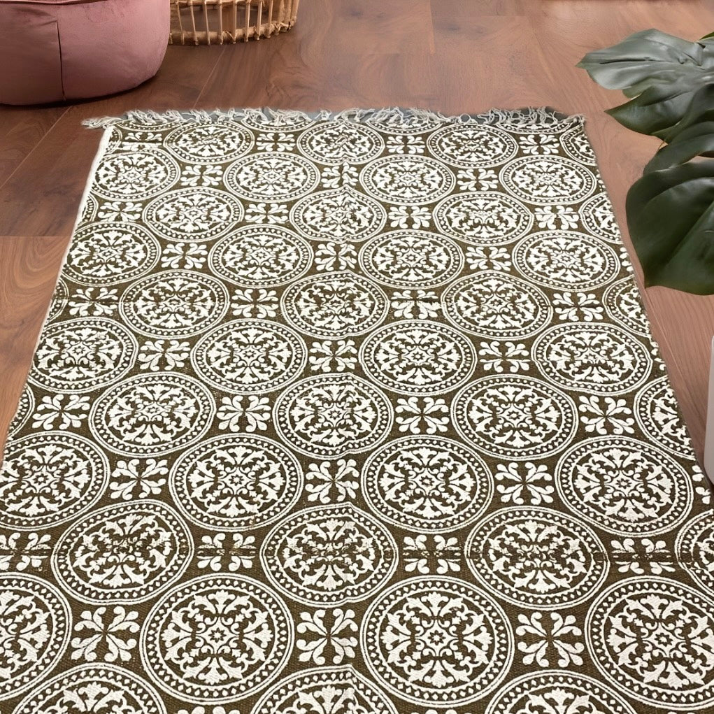 6.7x4 ft brown and beige mandala patterned circular ethnic motif dhurrie with tassels, handwoven and styled in a cozy living room