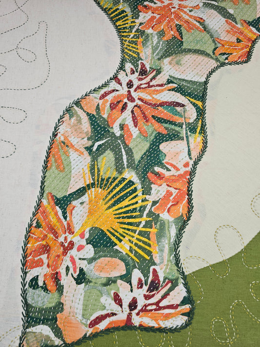 Detailed view of freeform embroidery and appliqué stitching on textile wall art, inspired by Indian kantha work