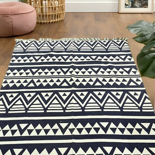 Handwoven black and white 6x4 ft cotton dhurrie with zigzag triangle design, perfect for contemporary spaces