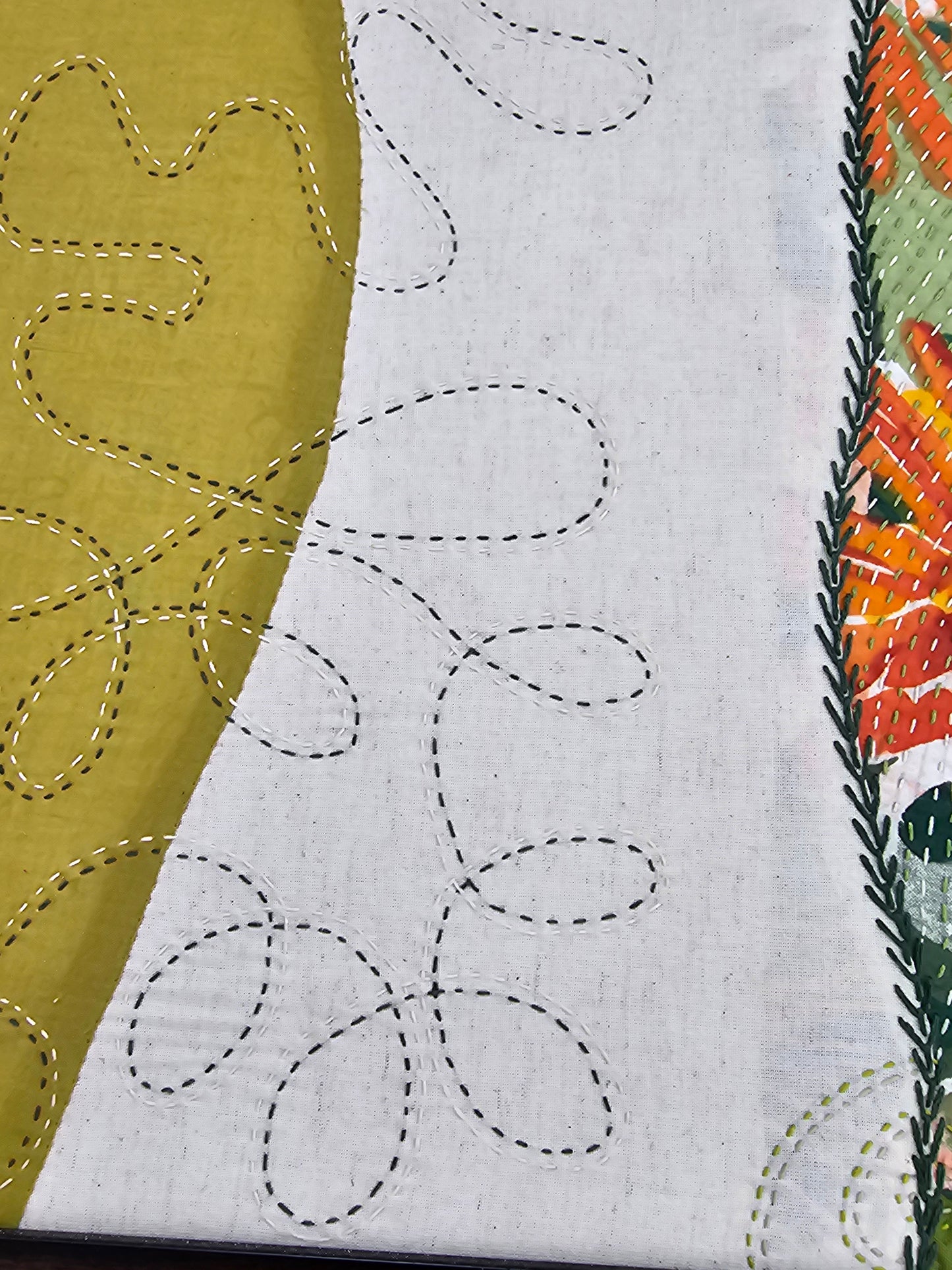 Side view showing texture of fabric art and depth of natural wooden frame for wall hanging decor