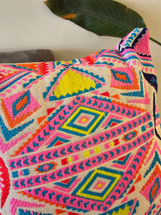 Colorful patterned fabric with geometric designs on a plain background