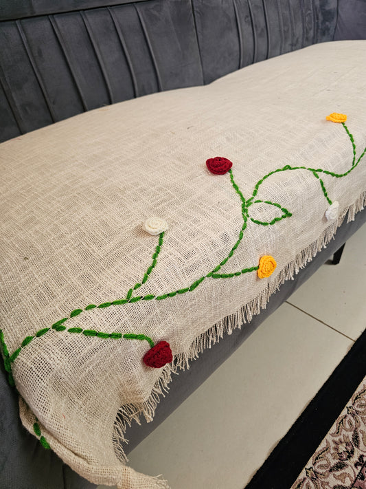 Decorative pillow with embroidered flowers on a couch