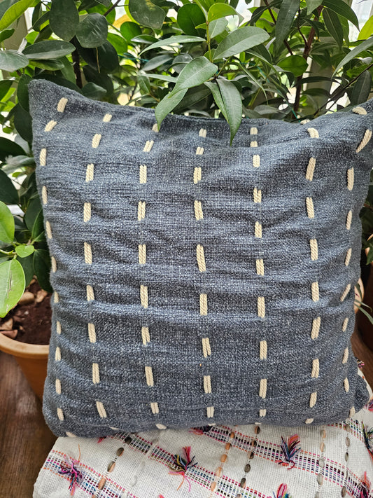 dark grey cushion cover with delicate white embroidery