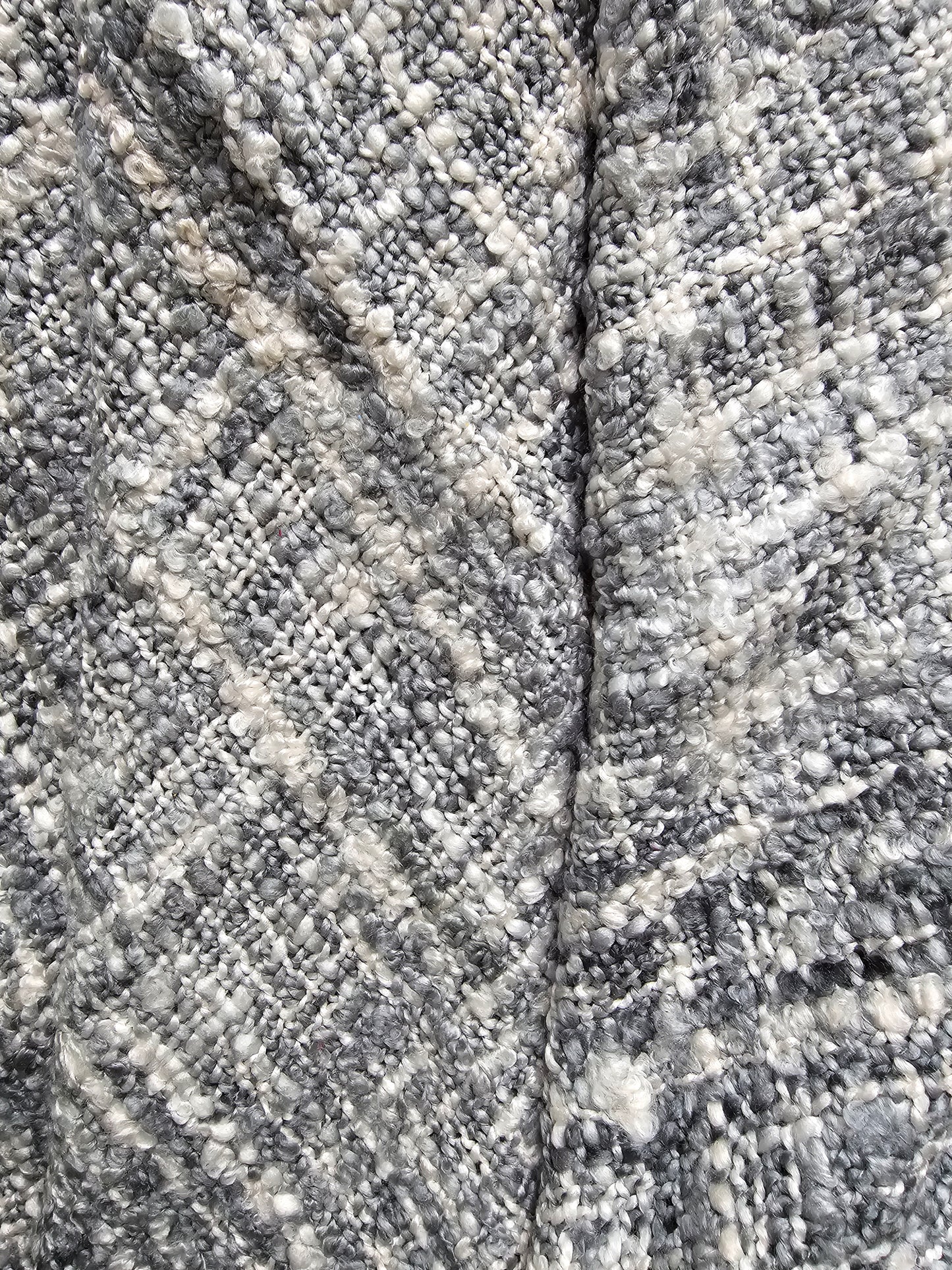 Close-up of textured stone surface with a crack running through it