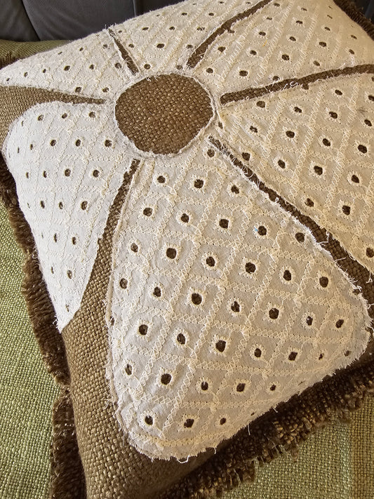 Close-up of a textured fabric with a floral pattern on a green background