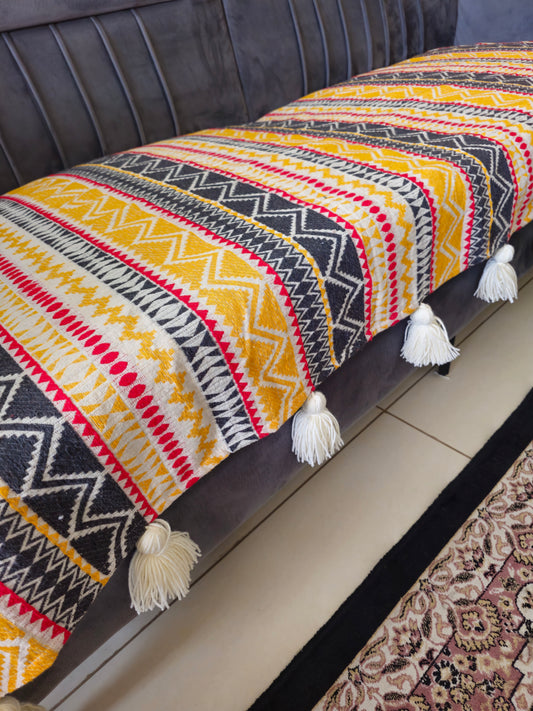 yellow sofa cover with tassels