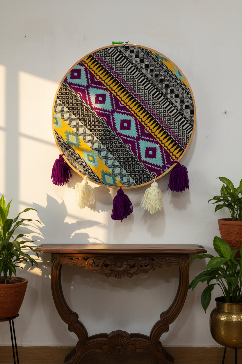 Decorative hoop with geometric pattern and tassels on a white background