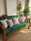 5-piece handloom cushion set featuring white tassel covers and pink and blue frilled covers on a sofa