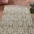 6.7x4 ft brown and beige mandala patterned circular ethnic motif dhurrie with tassels, handwoven and styled in a cozy living room