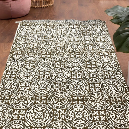 6.7x4 ft brown and beige mandala patterned circular ethnic motif dhurrie with tassels, handwoven and styled in a cozy living room