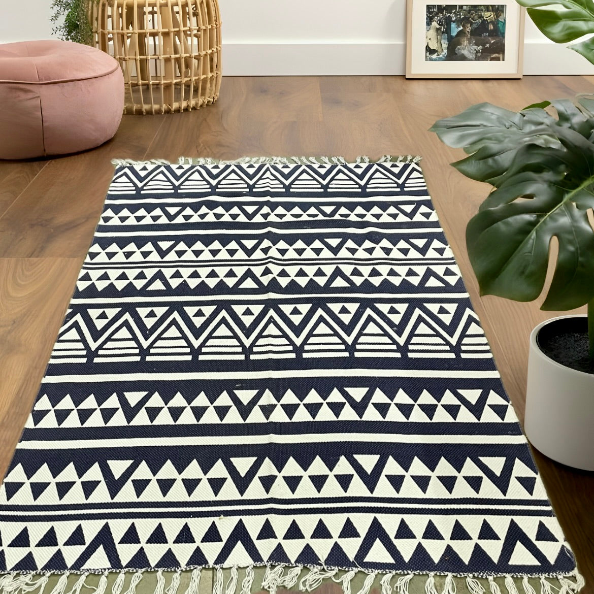 6x4 ft black and white zigzag triangle pattern cotton dhurrie rug, handwoven and laid in a modern living room