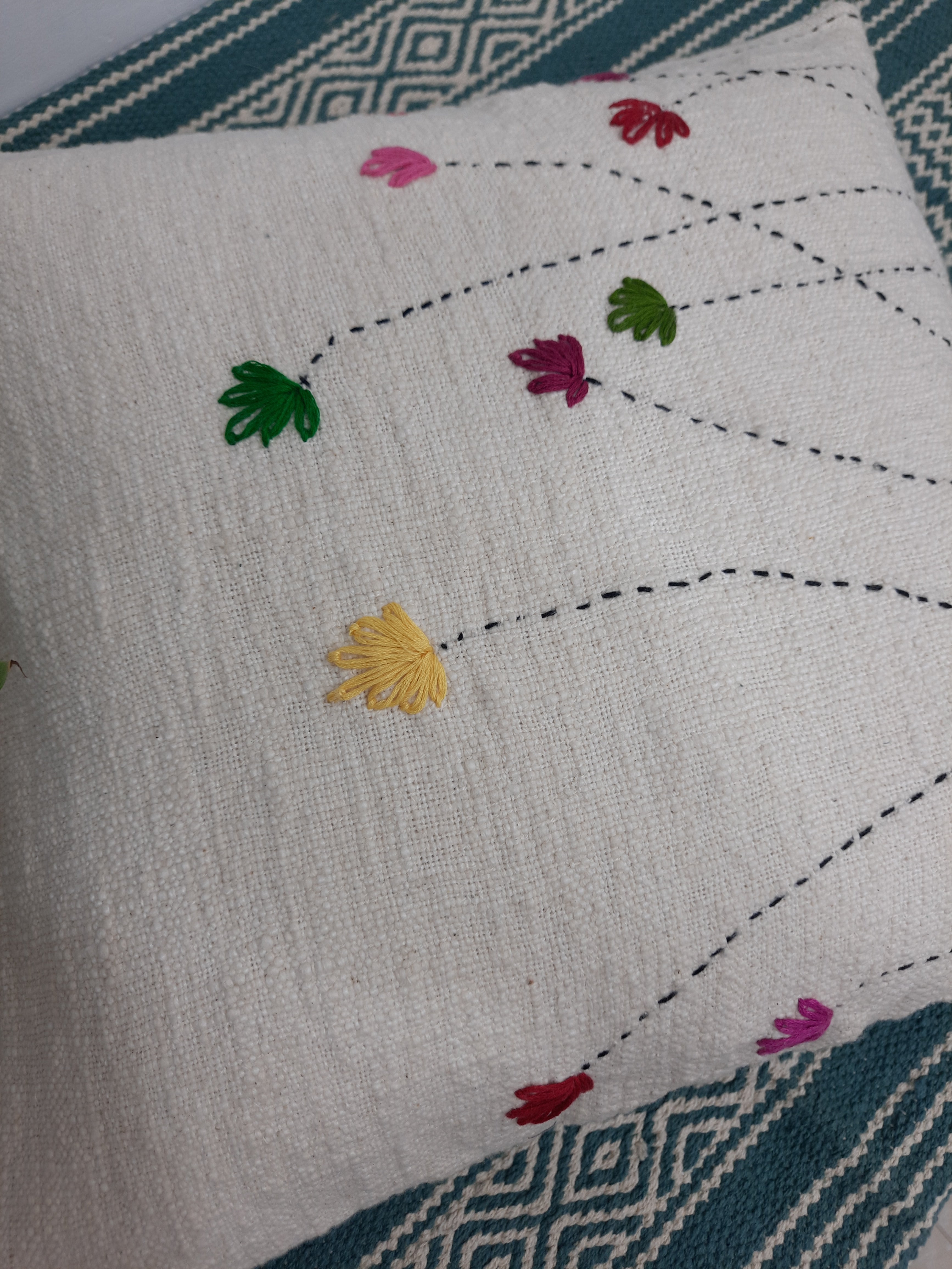 Boho-style cushion with off-white textured fabric and tulip design