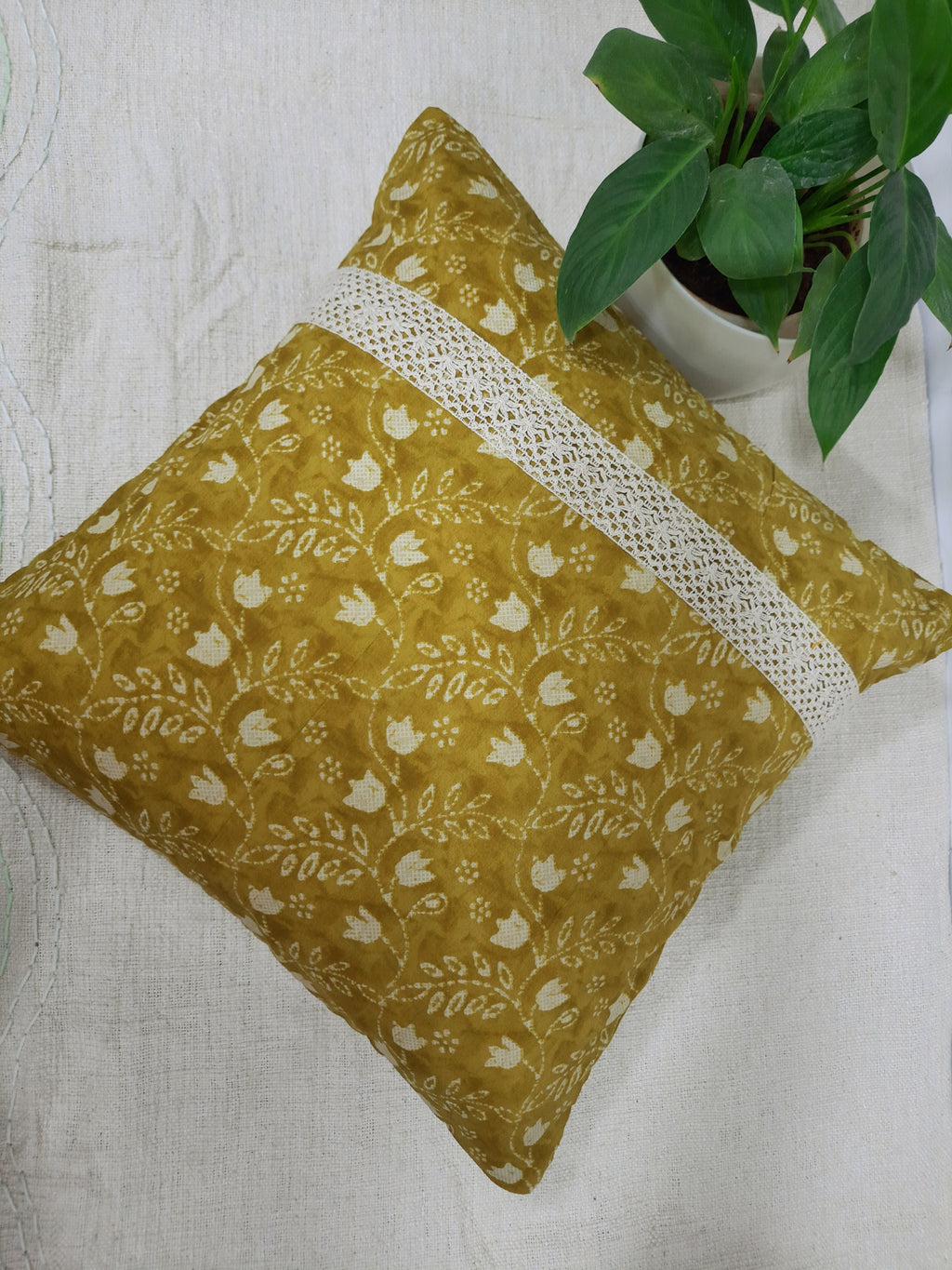 Boho yellow cushion with floral design and lace edging