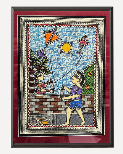 Framed artwork of two people flying kites with a colorful border.