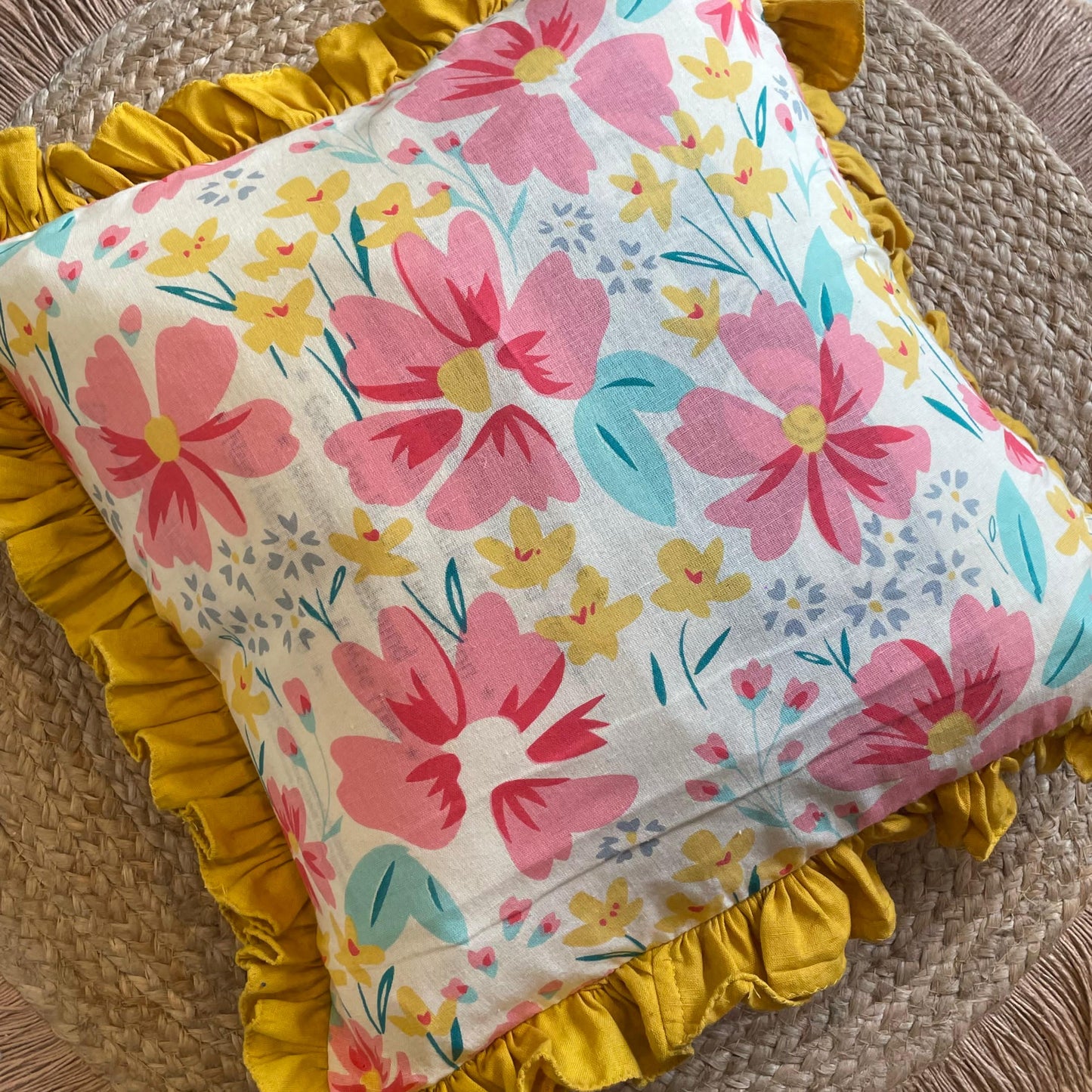 Decorative floral throw pillow styled on white couch