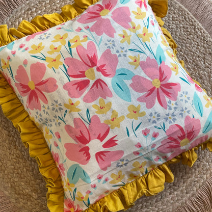 Decorative floral throw pillow styled on white couch
