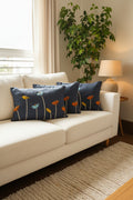Decorative pillow with floral patterns on a stand in a room setting.