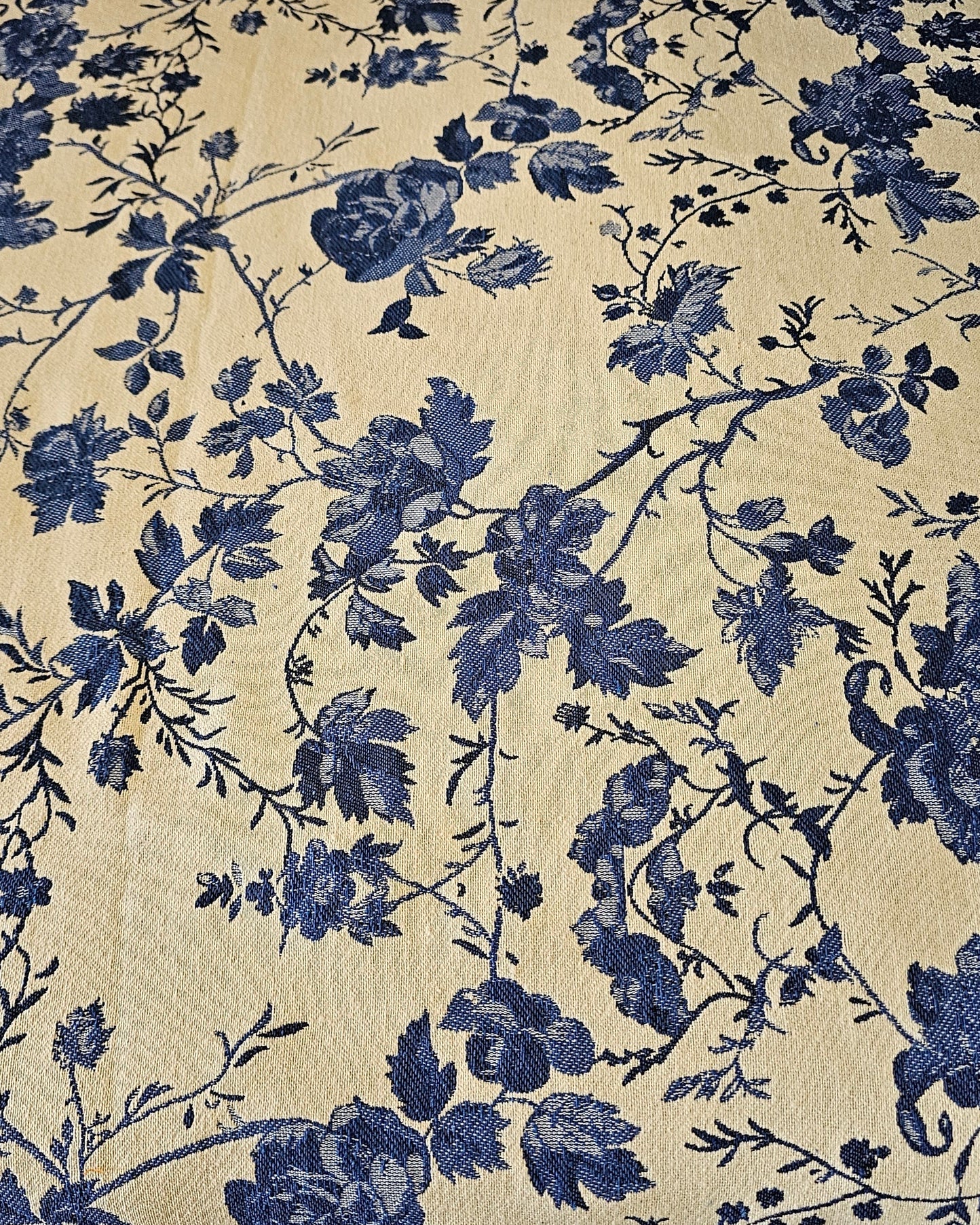 Floral patterned fabric with blue flowers on a beige background