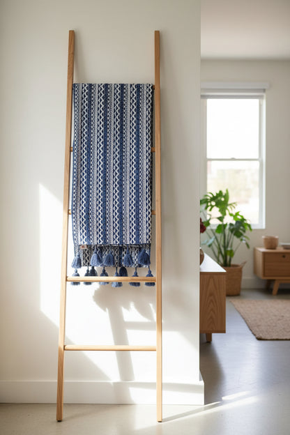 Folded handloom blue geometric sofa cover with woollen tassels”