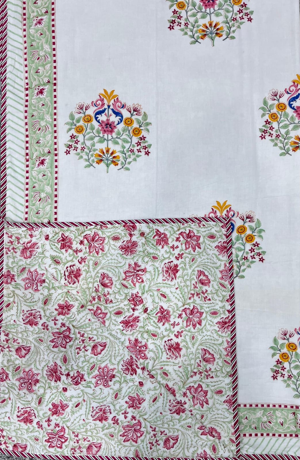 Floral and border patterns on a white fabric background