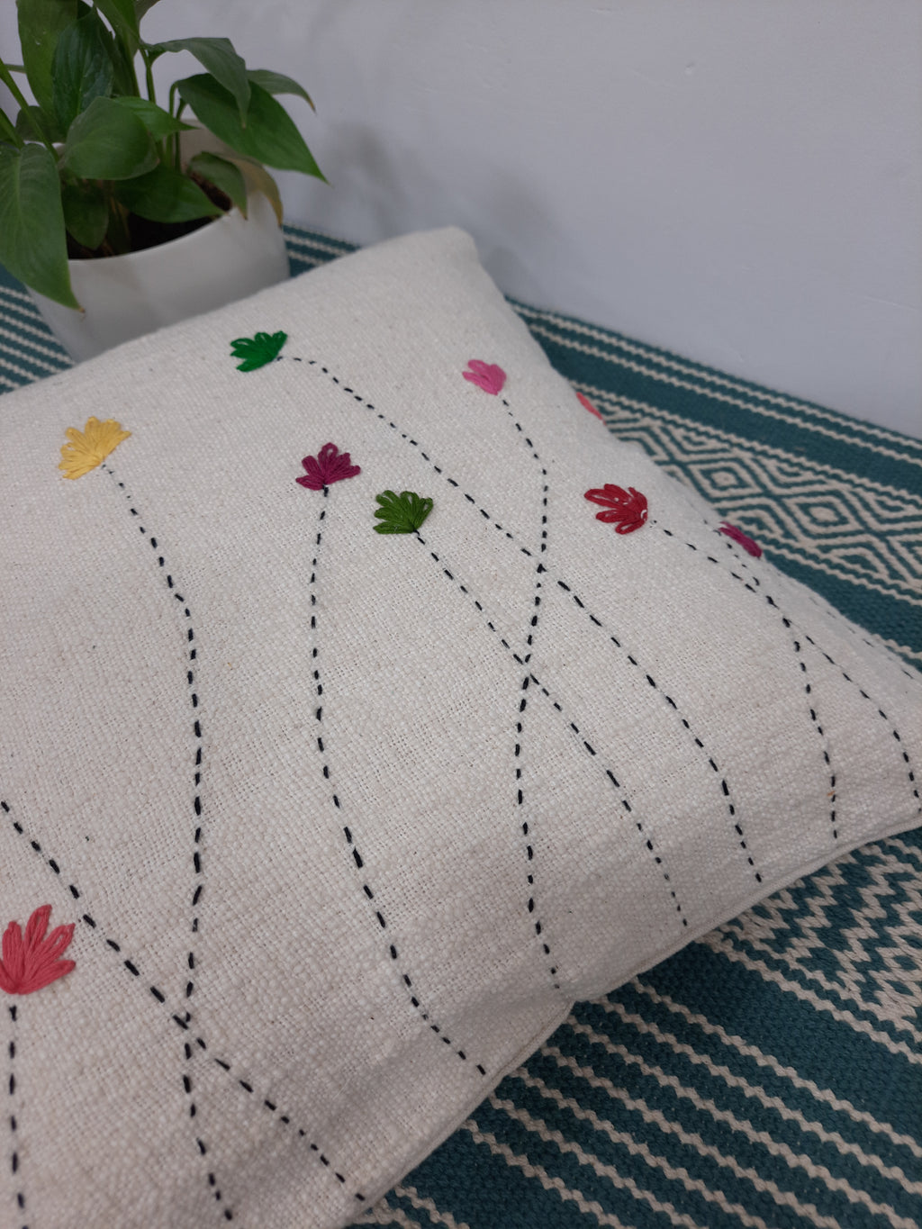 Handcrafted floral embroidery cushion in natural fiber blend
