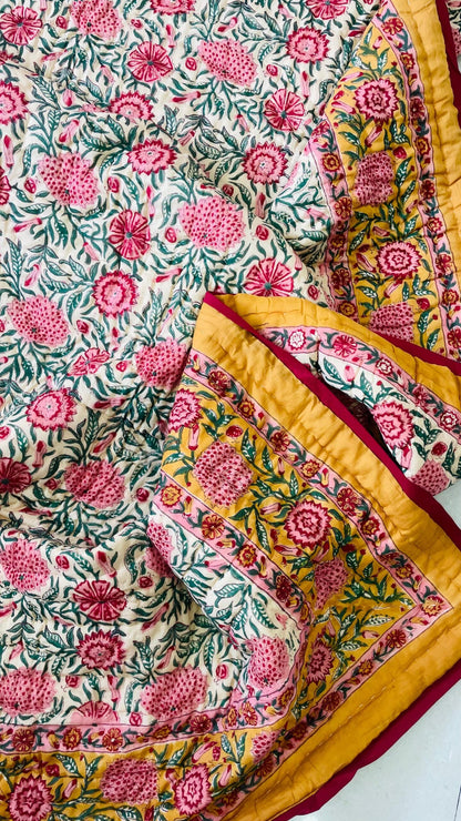 Floral patterned fabric with pink and yellow colors on a white background
