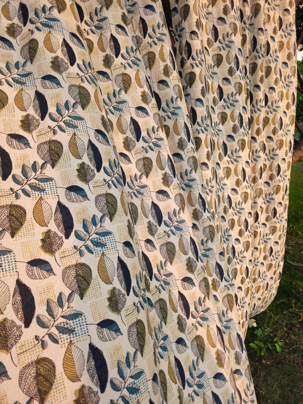 Close-up of a fabric with a leaf pattern on a natural background
