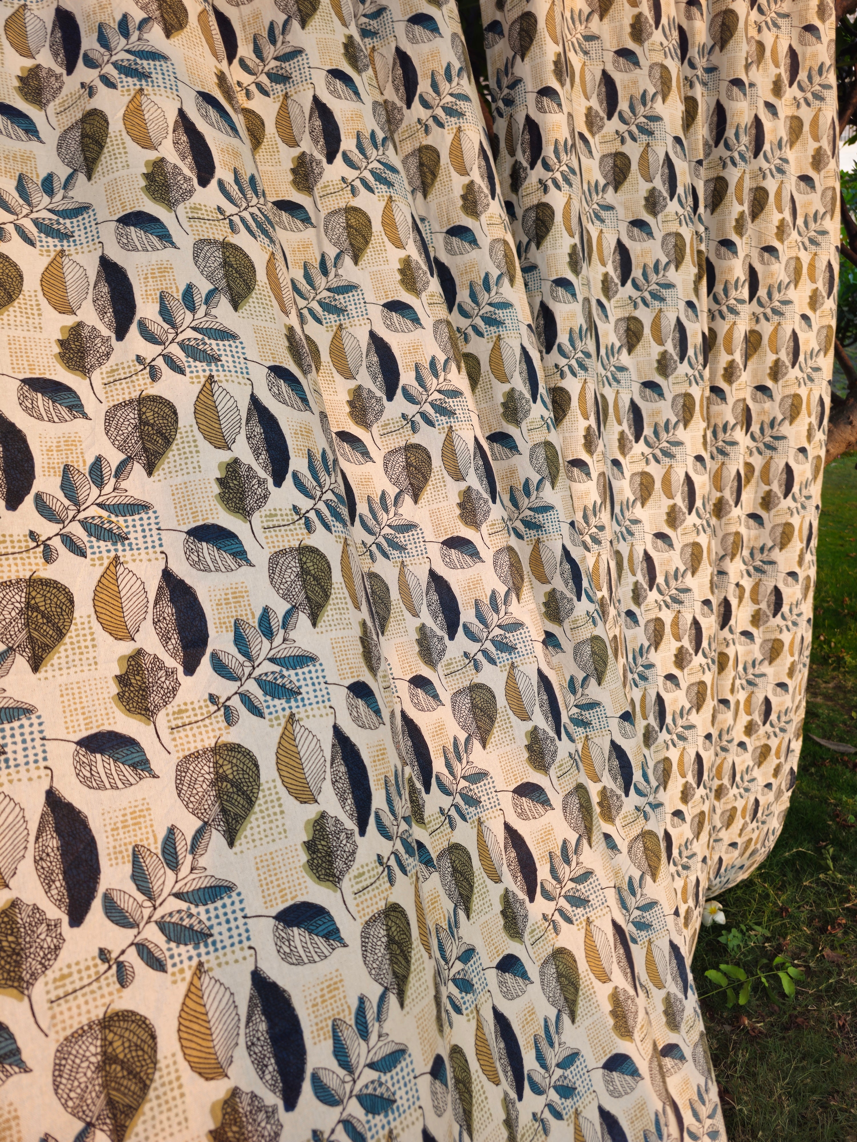 Close-up of a fabric with a leaf pattern on a natural background