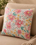 Pure cotton white cushion cover with hand-printed pink flowers and Kantha running stitch embroidery on a beige sofa.