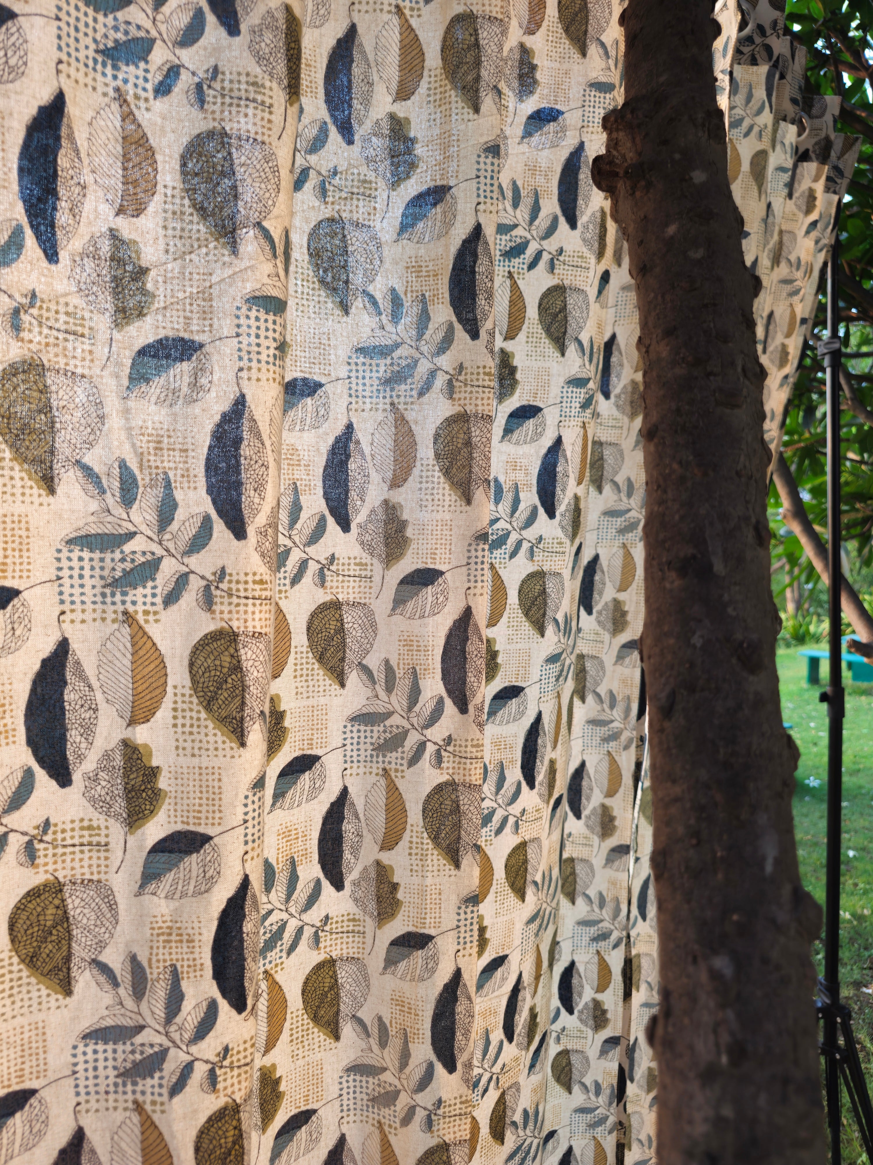 Textured fabric with leaf pattern in front of a natural background