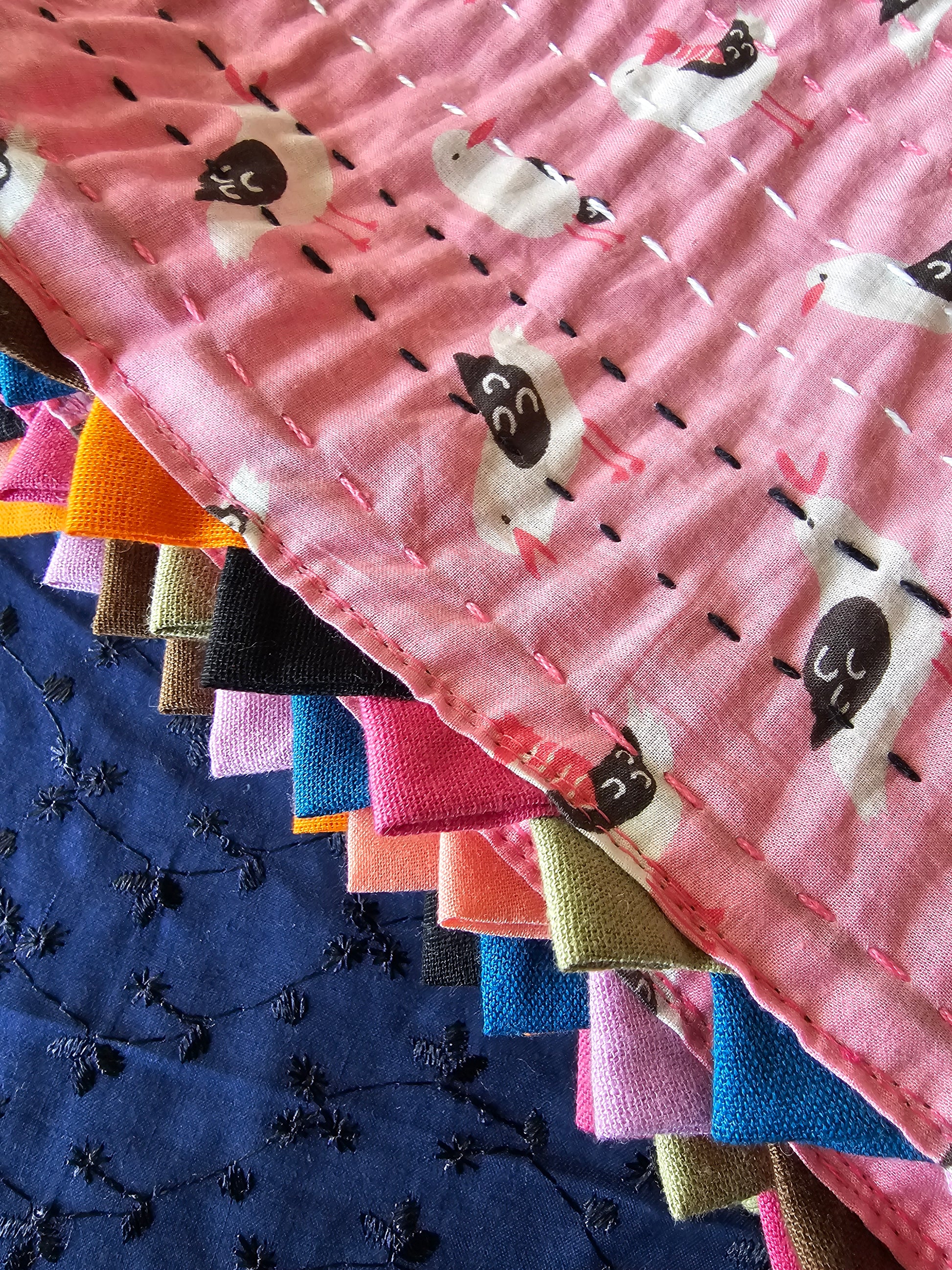 Stack of colorful fabric swatches with animal patterns