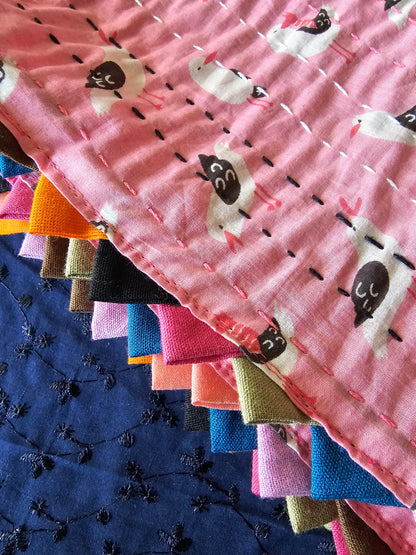 Stack of colorful fabric swatches with animal patterns