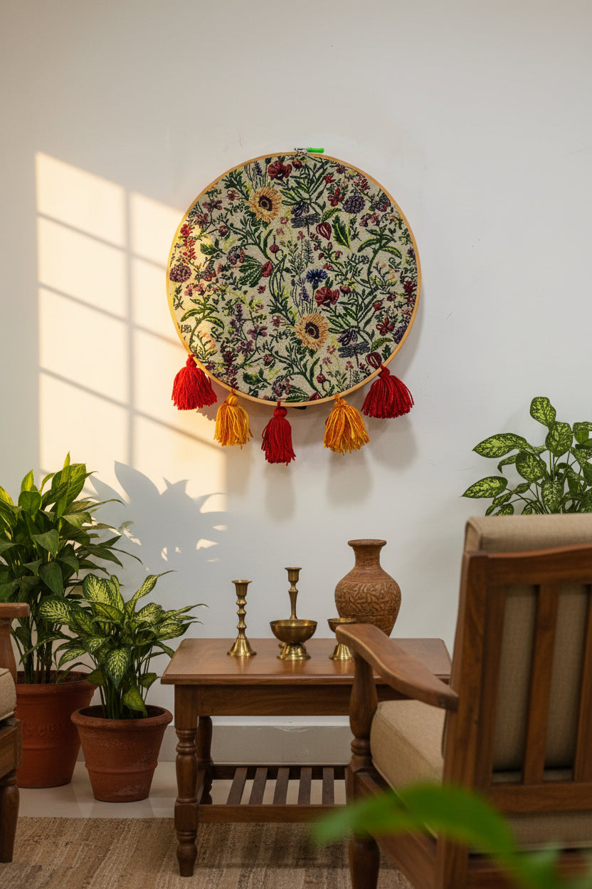 Embroidered hoop with floral pattern and colorful tassels on a white background