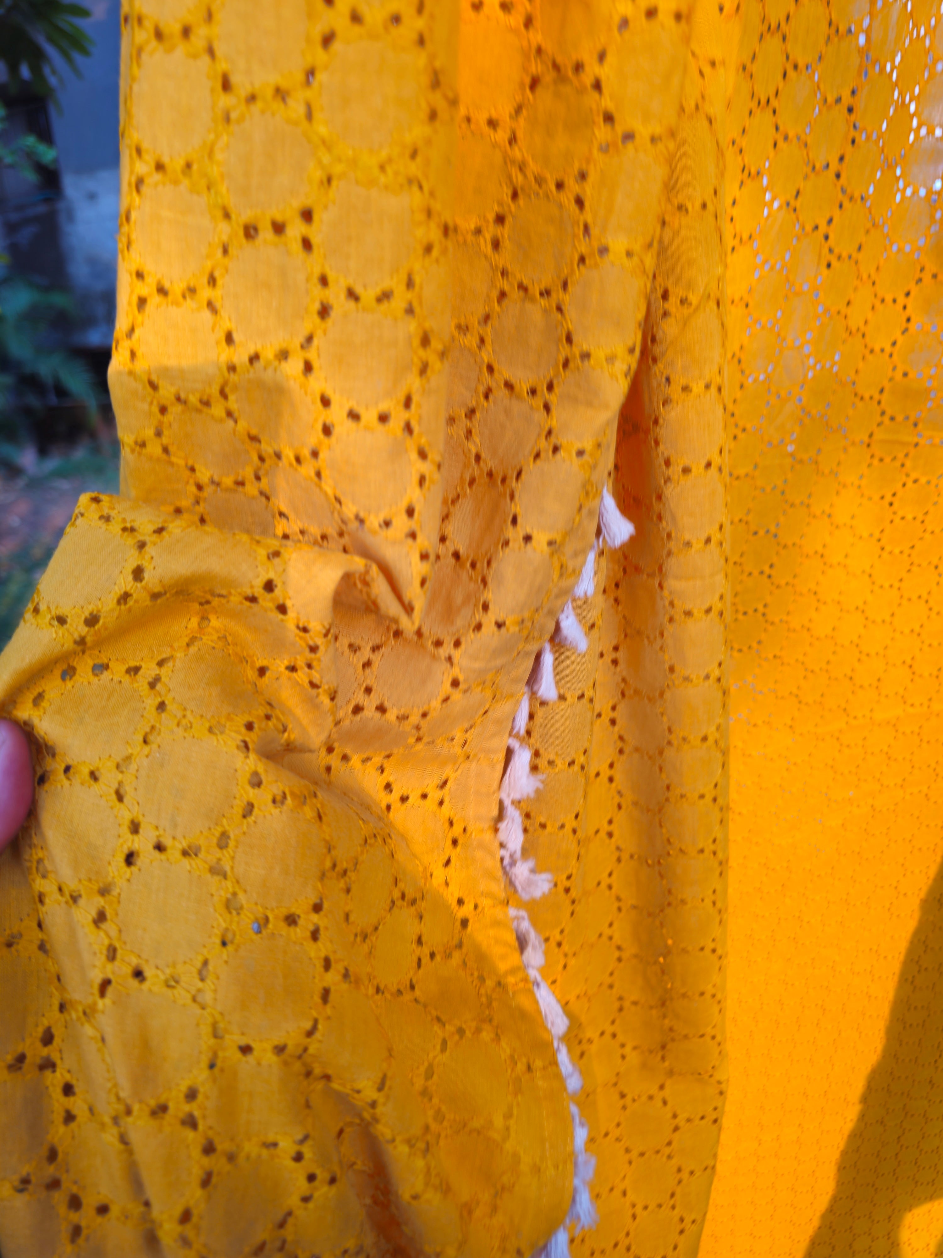 Close-up of yellow fabric with a subtle pattern