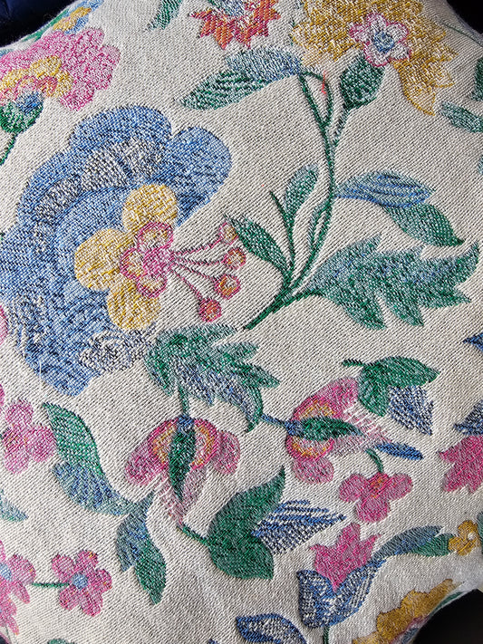 Close-up of floral embroidery on fabric with a neutral background