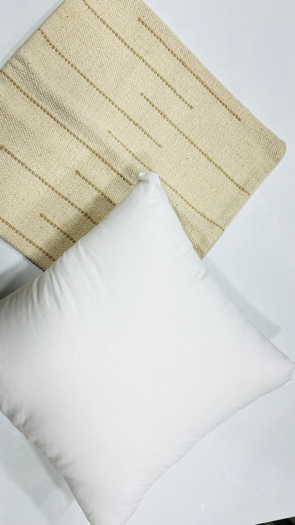 Vasaca boho off-white dotted line cotton throw pillow cover featuring subtle raised beige horizontal dot details and a hidden zipper on a natural cream cotton base.