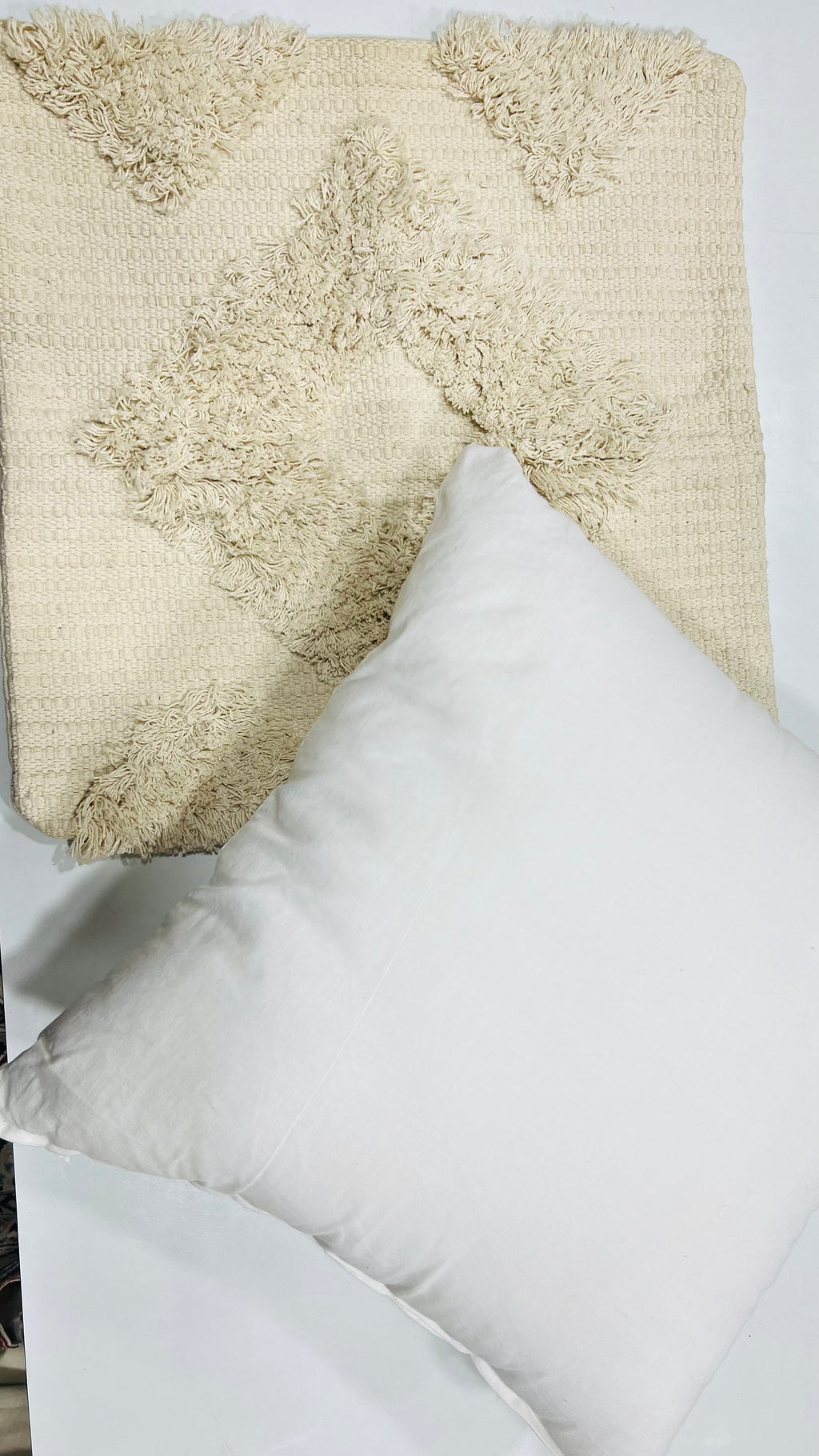 Vasaca boho off-white tufted cotton throw pillow cover featuring a tonal geometric diamond pattern, textured tufting details, and a hidden zipper on a natural cream cotton base.