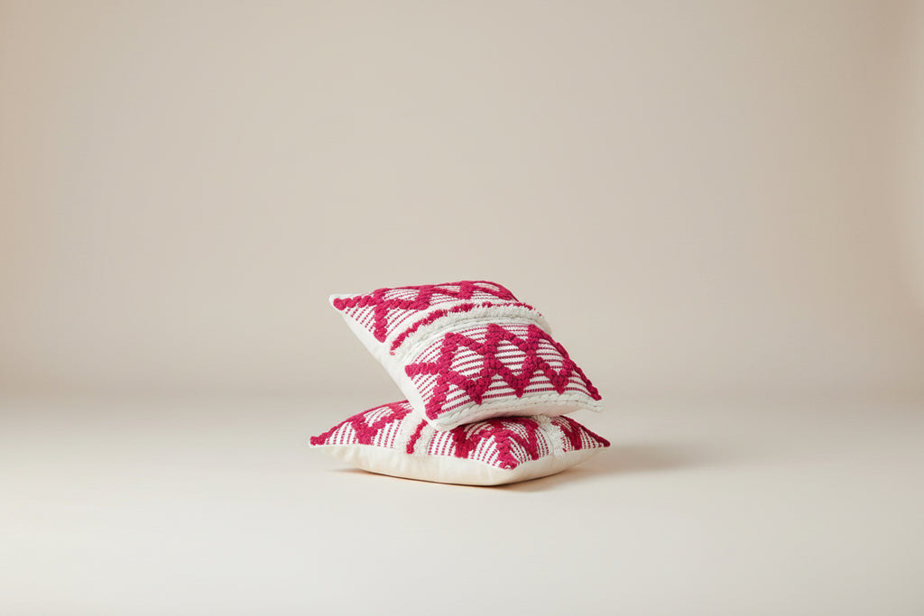 Vasaca boho pink tufted cotton throw pillow cover featuring a vibrant hot pink geometric diamond pattern, textured fringe details, and a hidden zipper on an off-white cotton base.