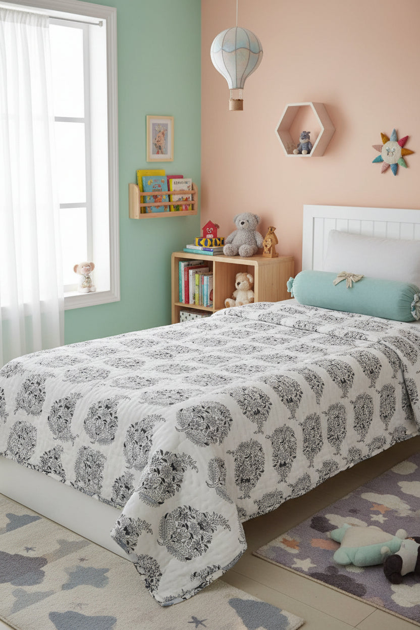 Close-up view of a Vasaca handblock printed cotton single bed razai featuring traditional charcoal floral motifs on a cream fabric with quilted texture.