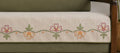 Vasaca oatmeal jute-cotton seat-only sofa runner with a hand-embroidered wildflower vine border in terracotta, pink, and green, tailored for a three-seater sofa.