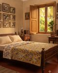 Close-up view of a Vasaca reversible handblock printed cotton single bed razai featuring a mustard yellow background with floral patterns and quilted texture.