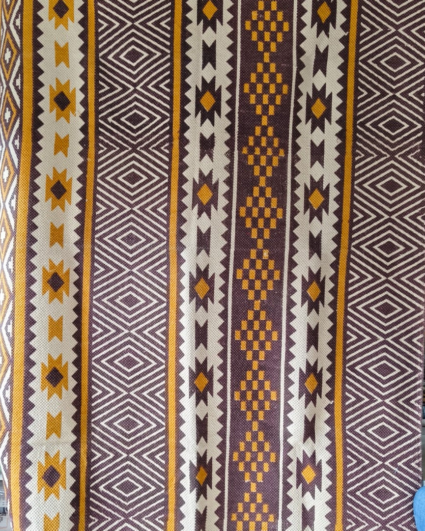 Vasaca rust brown and ochre yellow handwoven cotton jacquard runner rug with geometric tribal pattern, Aztec diamonds, and starburst panels.