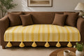 Vasaca yellow and white abstract zig-zag jacquard cotton seat-only sofa runner featuring intricate geometric stripes and chunky corner tassels, tailored for a three-seater sofa.