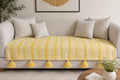 Vasaca yellow and white abstract zig-zag jacquard cotton seat-only sofa runner featuring intricate geometric stripes and chunky corner tassels, tailored for a three-seater sofa.