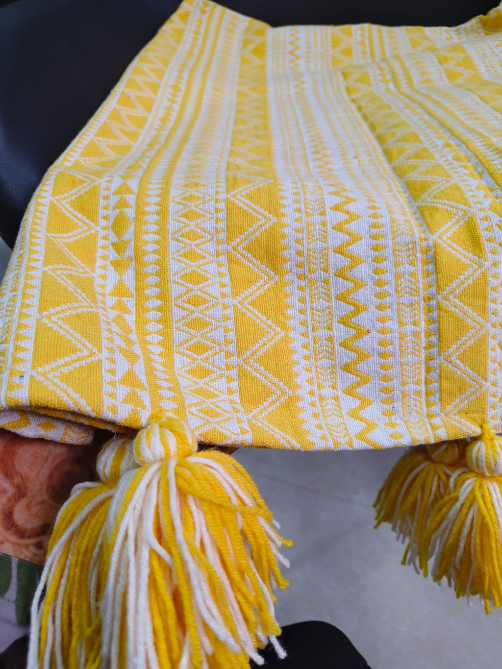 Vasaca yellow and white abstract zig-zag jacquard cotton seat-only sofa runner featuring intricate geometric stripes and chunky corner tassels, tailored for a three-seater sofa.