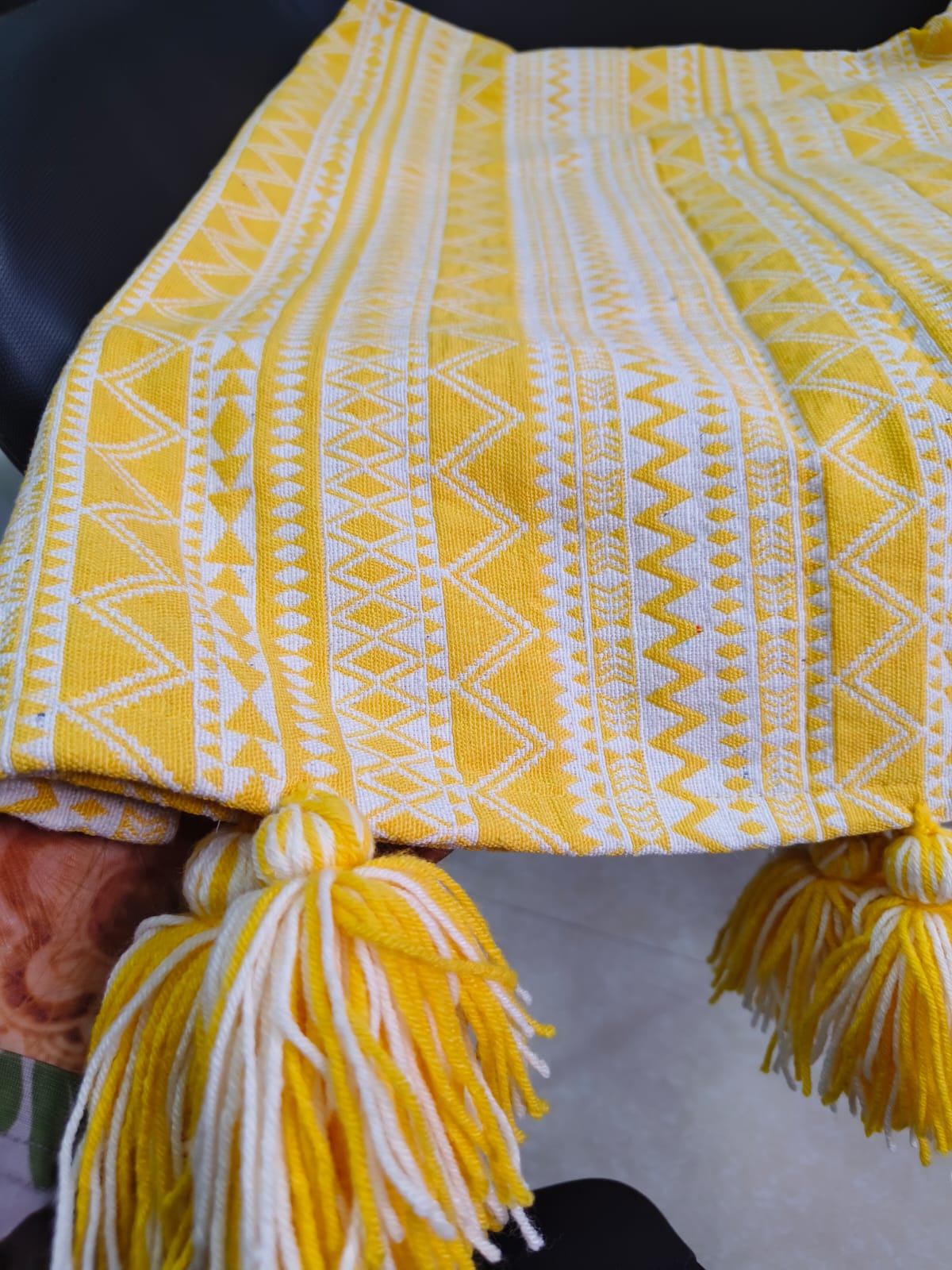 Vasaca yellow and white abstract zig-zag jacquard cotton seat-only sofa runner featuring intricate geometric stripes and chunky corner tassels, tailored for a three-seater sofa.