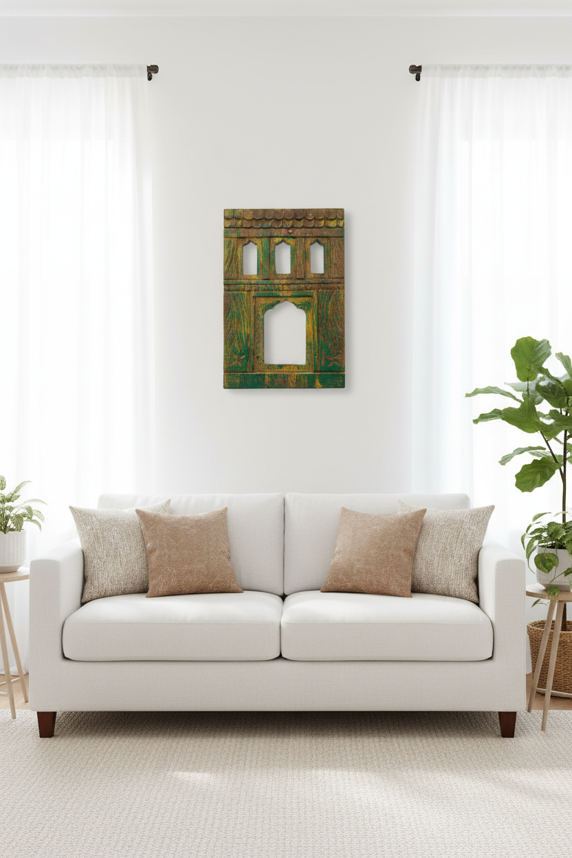 White sofa with beige pillows in a room with a decorative wall piece and plants.