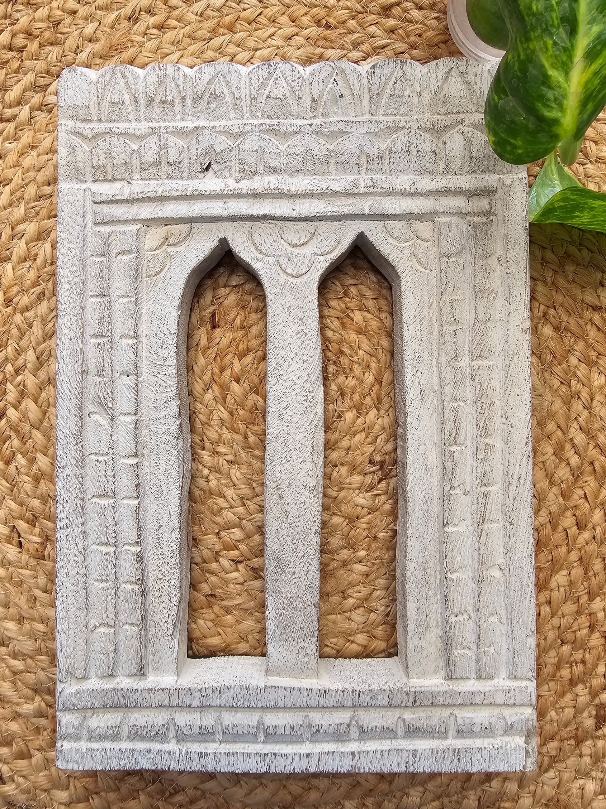 Decorative wooden wall art with woven design on a textured surface